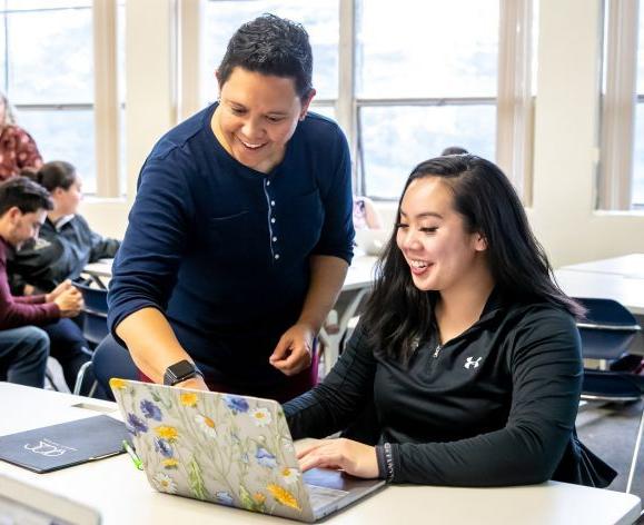 student and professor interacting in classroom